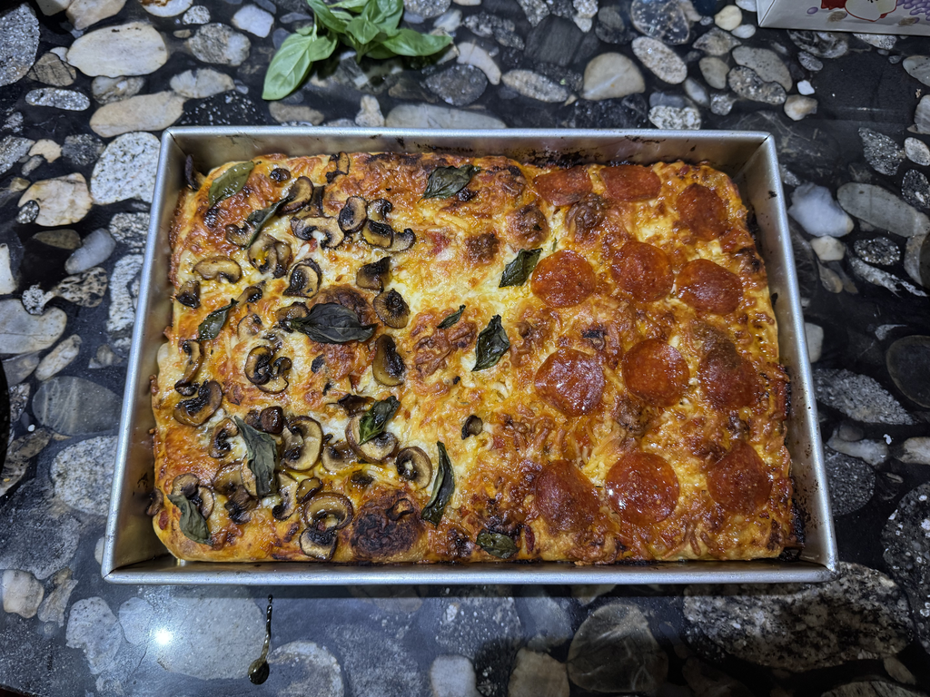 Fully cooked focaccia pizza with browned cheese and crust