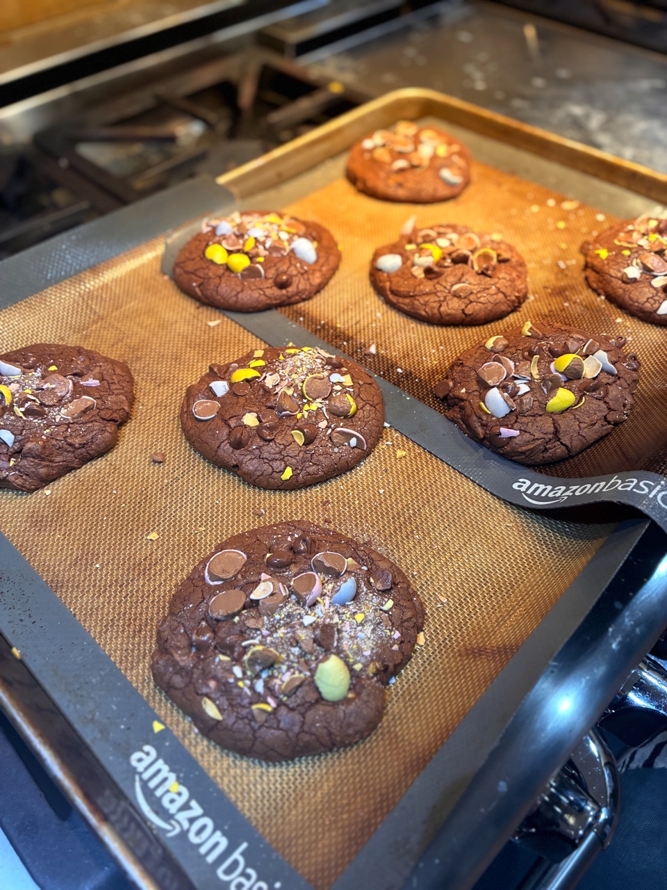 Cookies with colorful candy pieces on a baking sheet